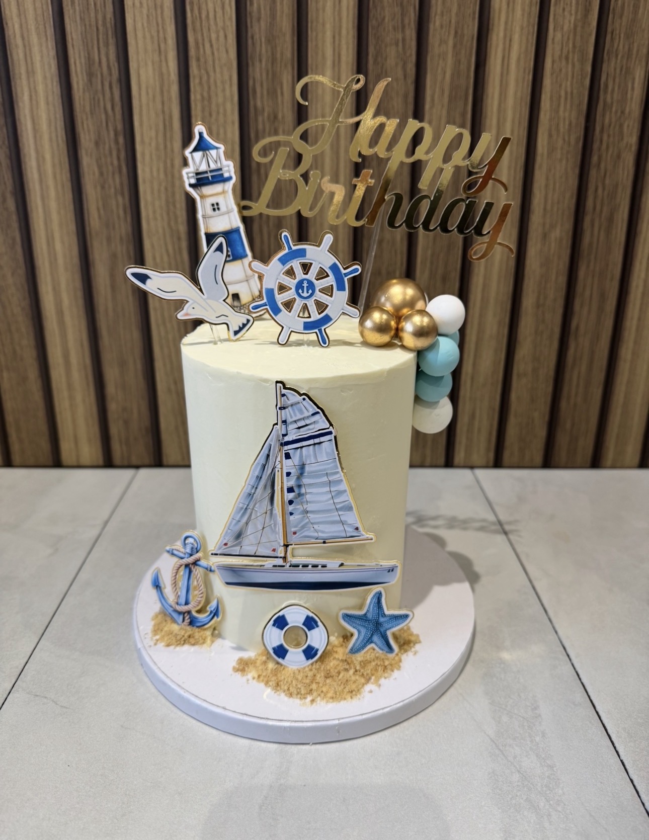 Nautical themed birthday cake with sailboat